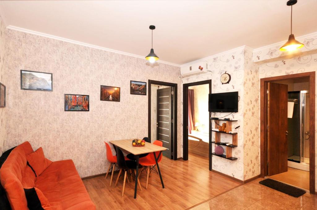 una sala de estar con una mesa y un sofá en Apartment Art Django Old Avlabari, en Tiflis