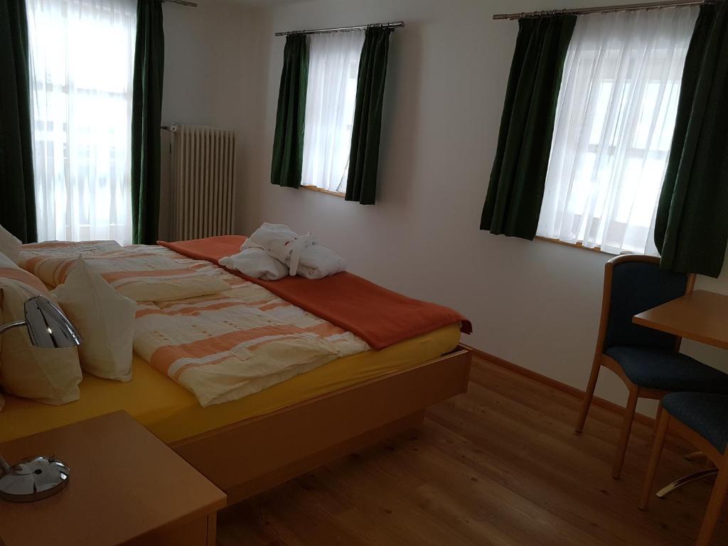 a bedroom with a bed with two towels on it at Der Perweinhof in Donnersbachwald