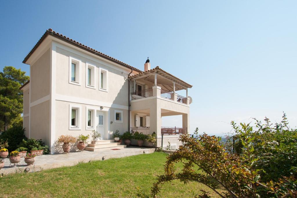 a white house with a view of the ocean at Villa Sunny in Skiathos