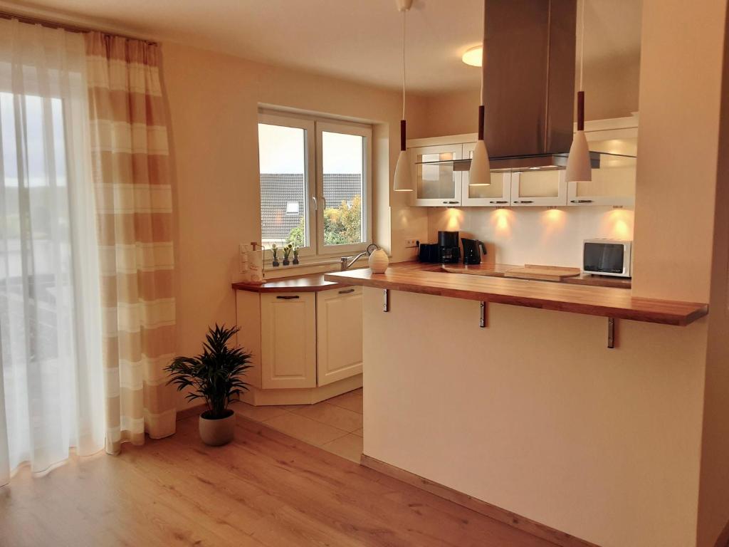 a kitchen with a counter and a sink and a window at Wanderglück Rotenfels in Traisen