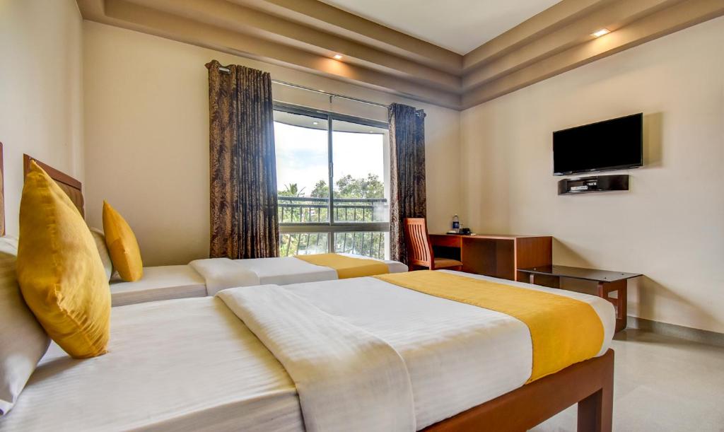 Postel nebo postele na pokoji v ubytování Hotel Garden Inn