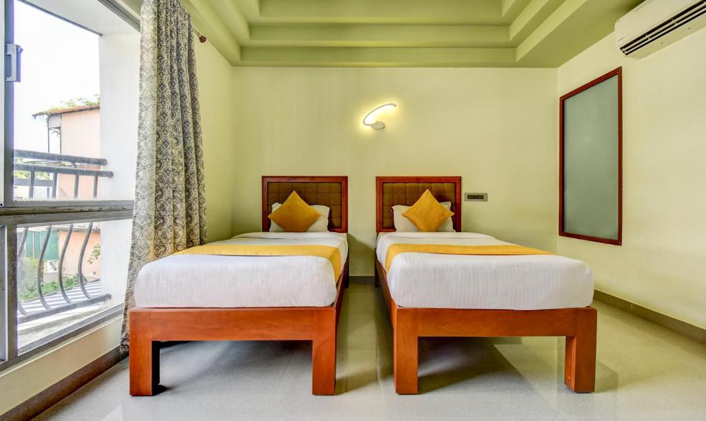 Postel nebo postele na pokoji v ubytování Hotel Garden Inn