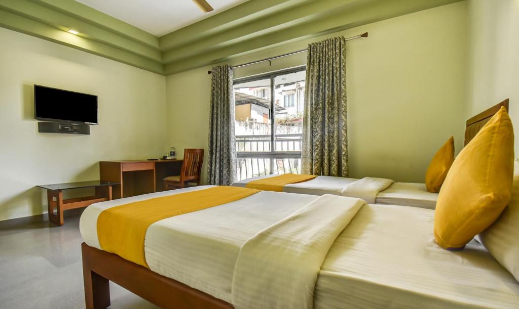 Postel nebo postele na pokoji v ubytování Hotel Garden Inn