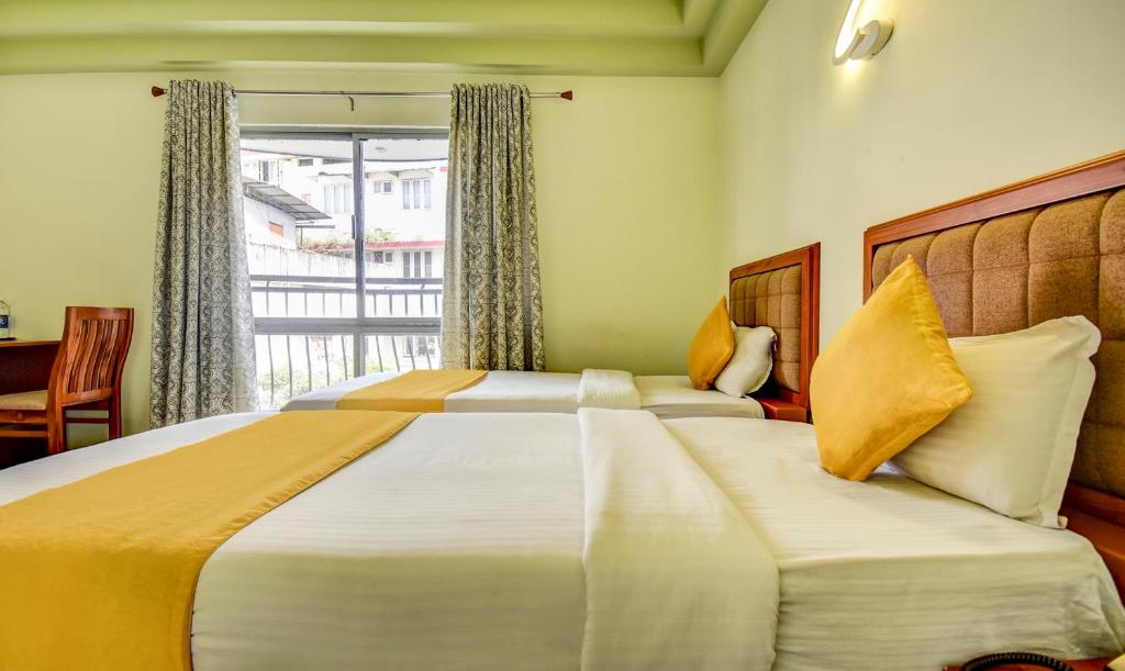 Postel nebo postele na pokoji v ubytování Hotel Garden Inn