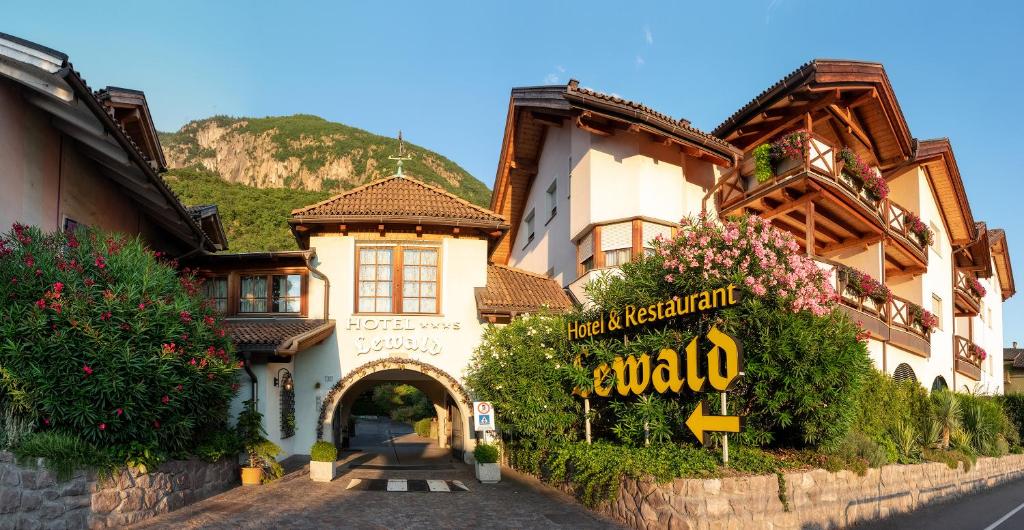 a building with a sign in front of it at Hotel Ristorante Lewald in Bolzano