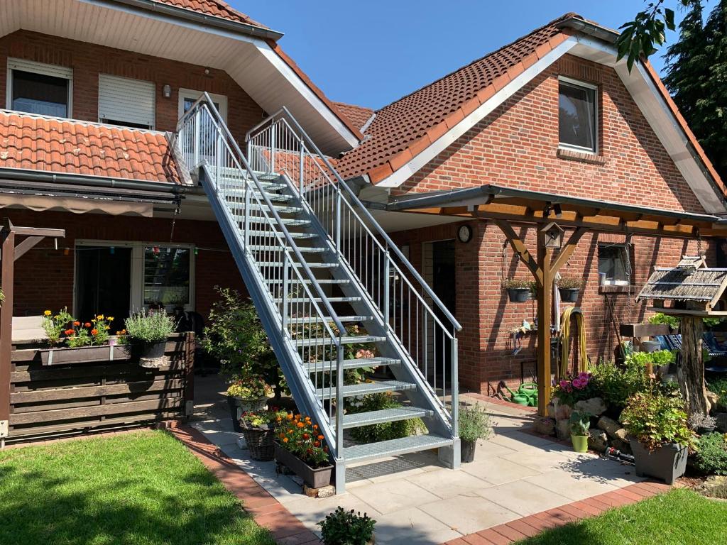 a house with a staircase in front of it at Ferienwohnung nahe Bentheimer Wald in Schüttorf