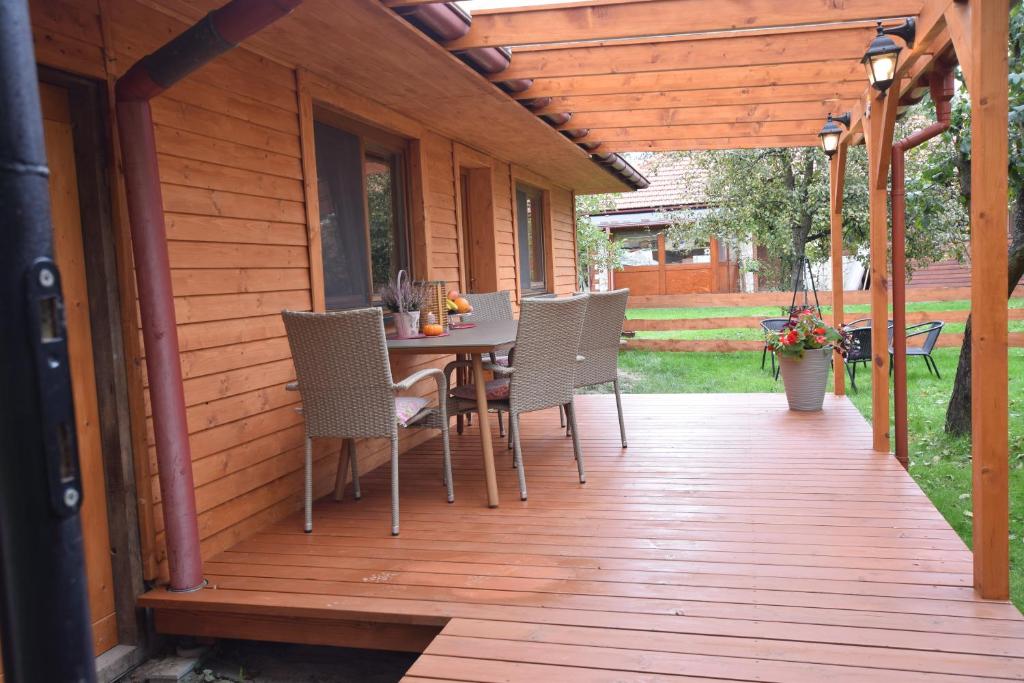 a wooden deck with a table and chairs on it at Domek Anielski in Zator