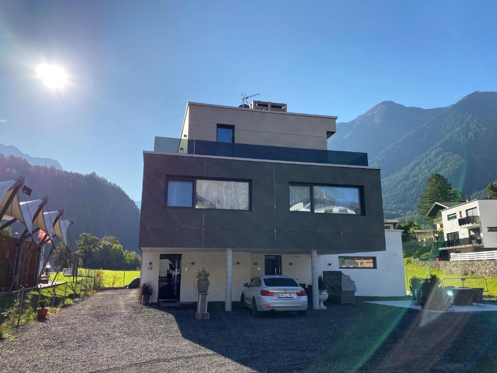 a house with a car parked in front of it at Ötztal Residenz in Oetz