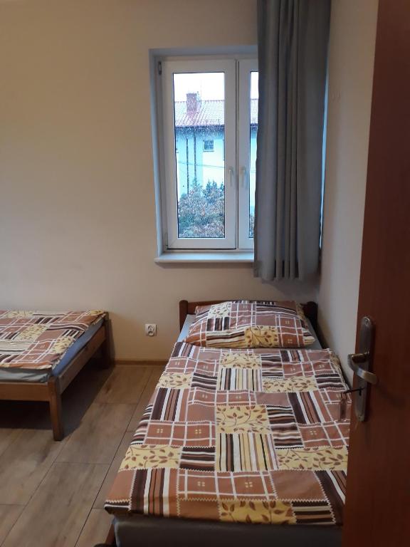Postel nebo postele na pokoji v ubytování Noclegi Pod Kasztanami