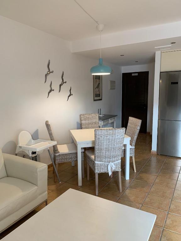 a living room with a table and chairs and a couch at Casa Achille in El Cotillo