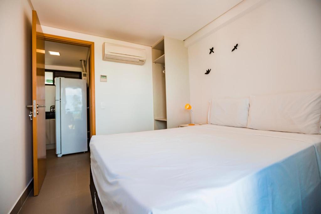 Кровать или кровати в номере Macuco Residence