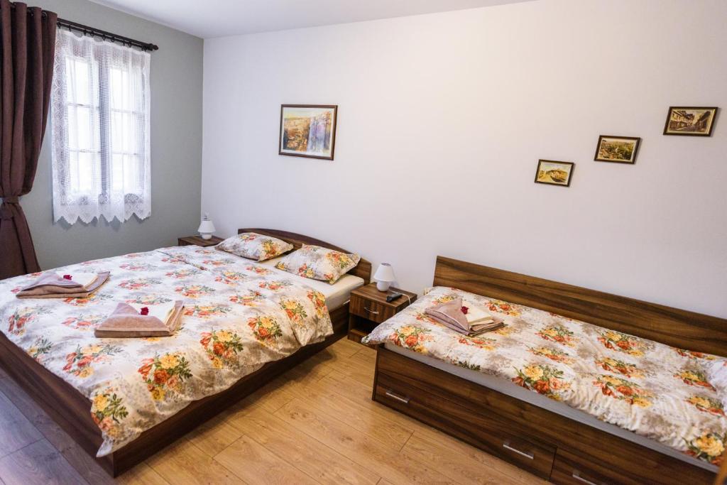 a bedroom with two beds and a window at Trapezitsa Apartment - free parking in Veliko Tŭrnovo