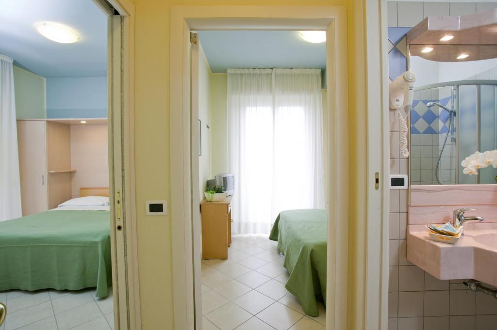 Postel nebo postele na pokoji v ubytování Hotel Rosso Blu
