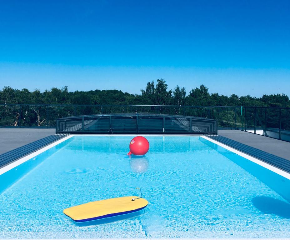 a swimming pool with a red ball and a red ball at Family Hel in Hel