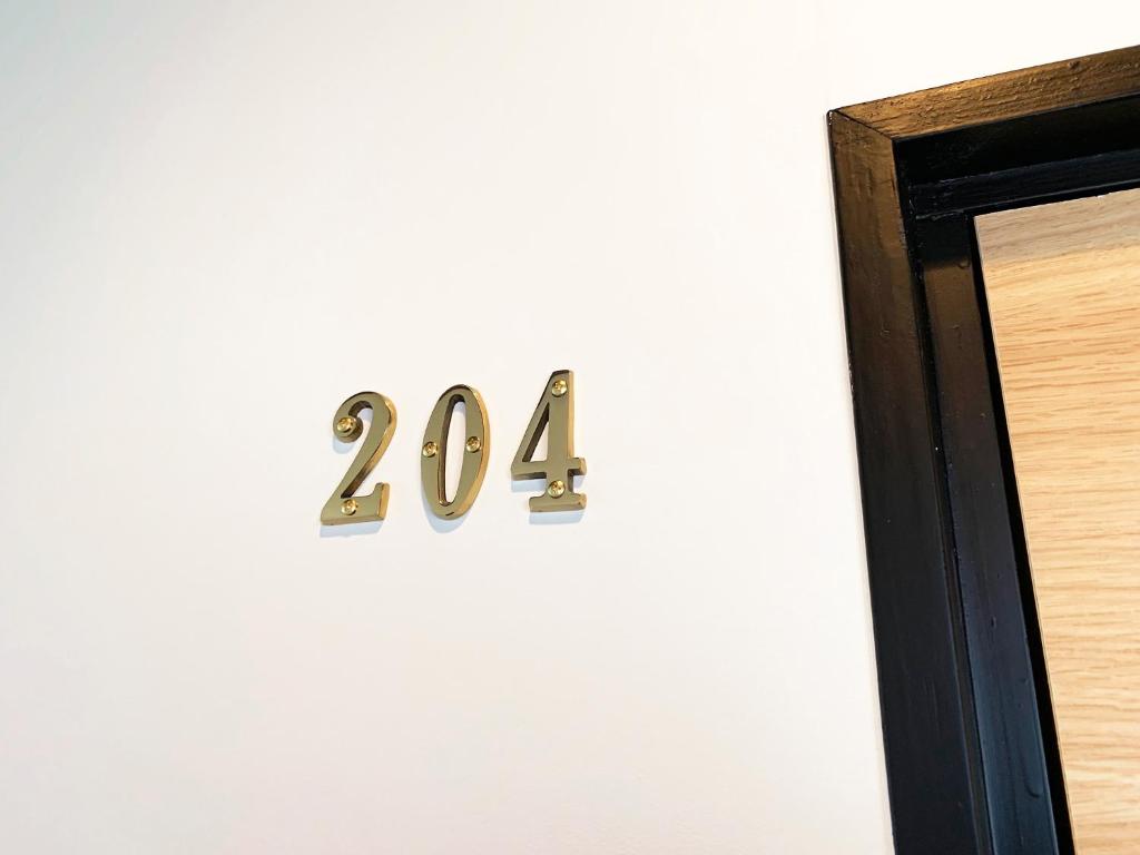 a metal number on a wall next to a door at Cactus Inn / Vacation STAY 51551 in Miyazaki