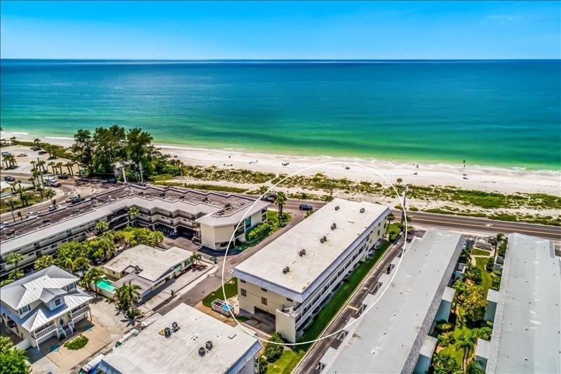an aerial view of a building next to the beach at Gulf Watch 204 Condo in Bradenton Beach