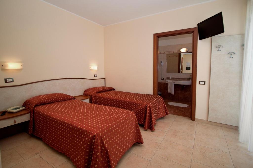 Postel nebo postele na pokoji v ubytování Hotel Harmony