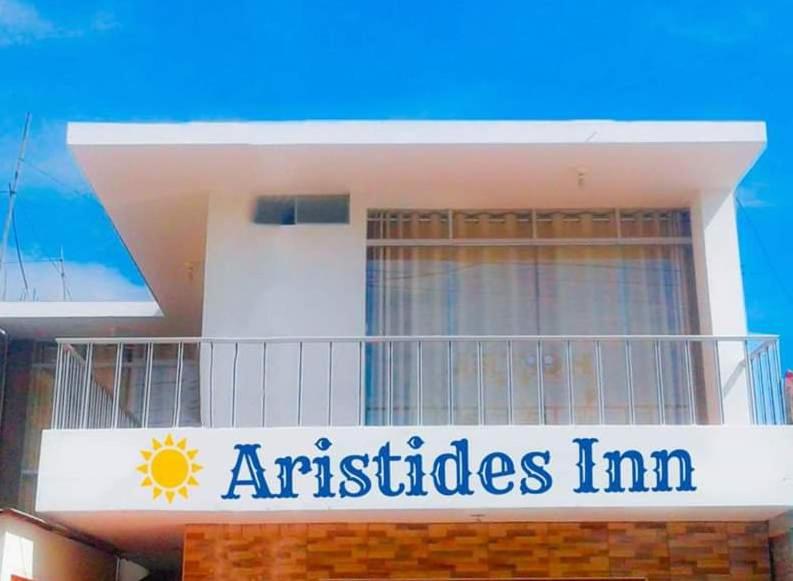 a building with a sign that reads aristides im at Aristides Inn in Huarmey