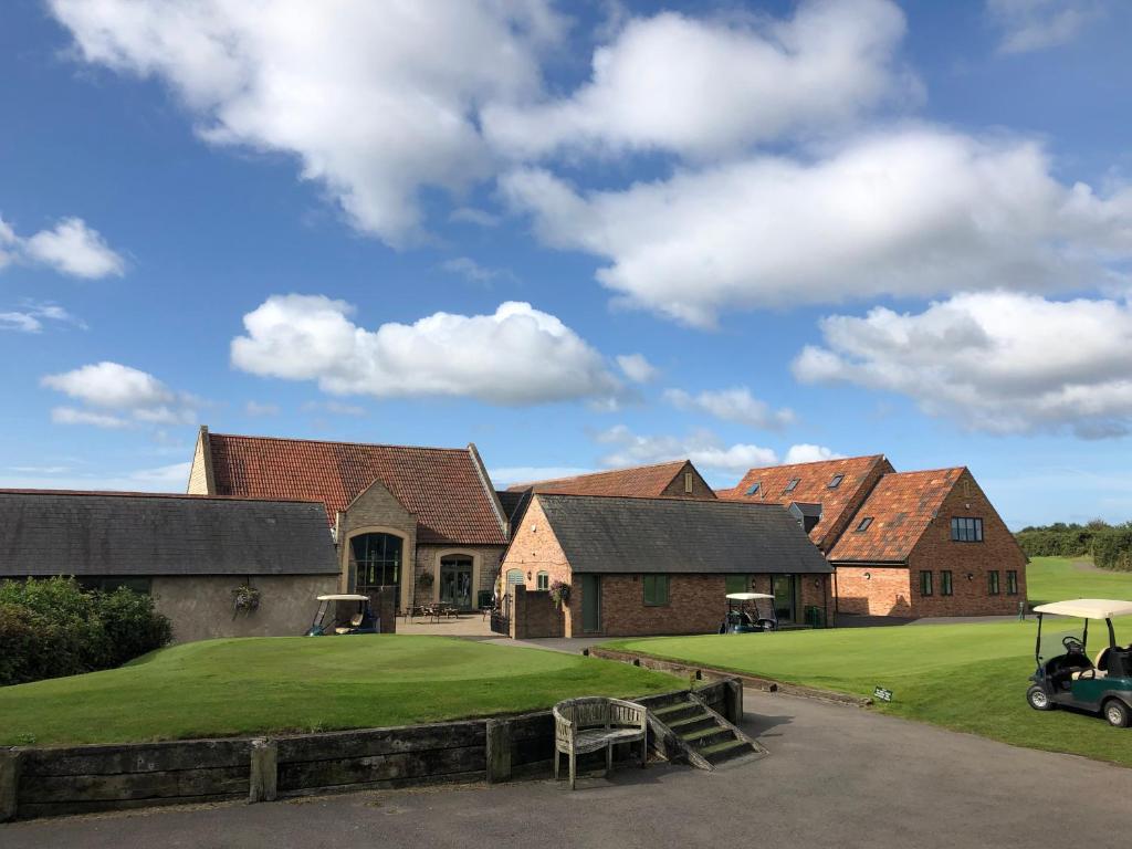 a group of houses with a green lawn at The Players Golf Club in Bristol