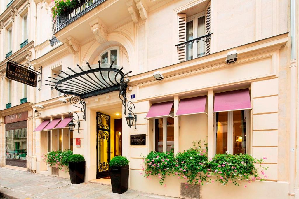 a building with pink awnings on a street at Queen Mary Opera in Paris