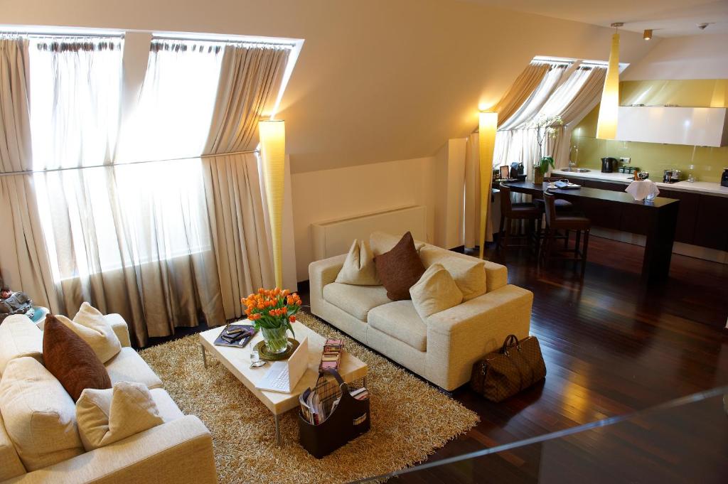 a living room with two couches and a table at MyPlace - Premium Apartments City Centre in Vienna