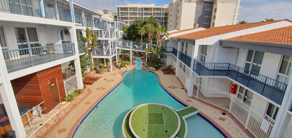 an aerial view of a swimming pool between two buildings at West Beach Lagoon 218 - Outstanding Value! in Perth