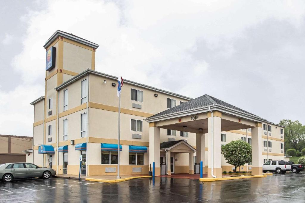 a hotel building with a car parked in a parking lot at Comfort Inn Schererville in Schererville