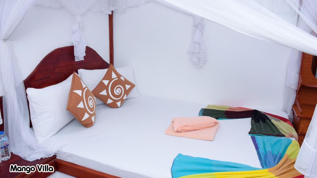 Postel nebo postele na pokoji v ubytování Mango Villa Sigiriya
