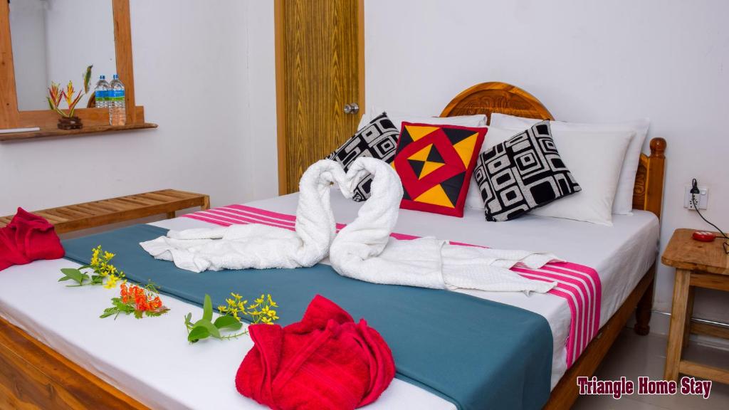 Postel nebo postele na pokoji v ubytování Triangle Home Stay