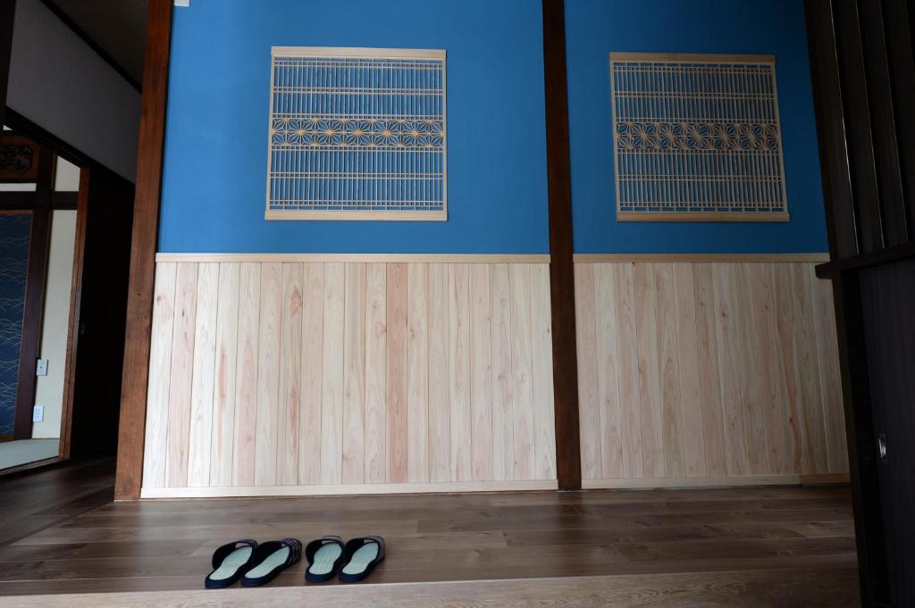 a room with two pairs of shoes on the floor at Guesthouse Iwase in Toyama