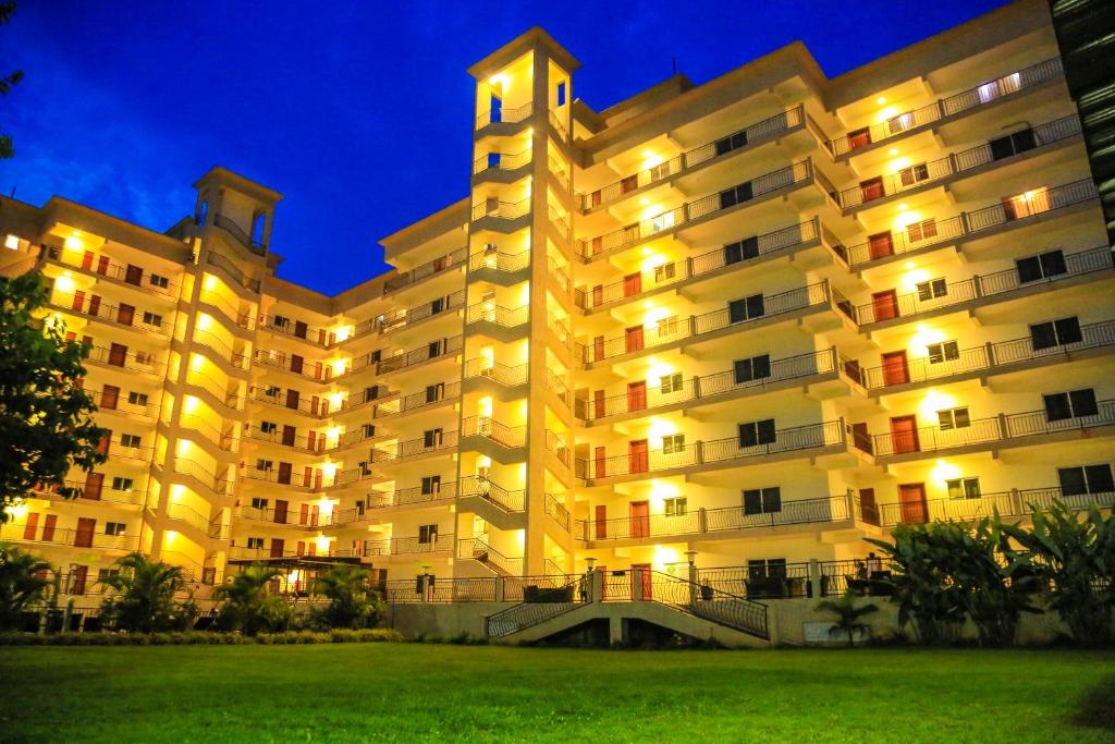 a large building with a clock tower at night at Executive Suites in Kigali