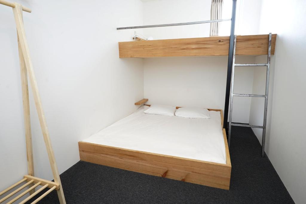 Postel nebo postele na pokoji v ubytování Santiago Guesthouse Hiroshima