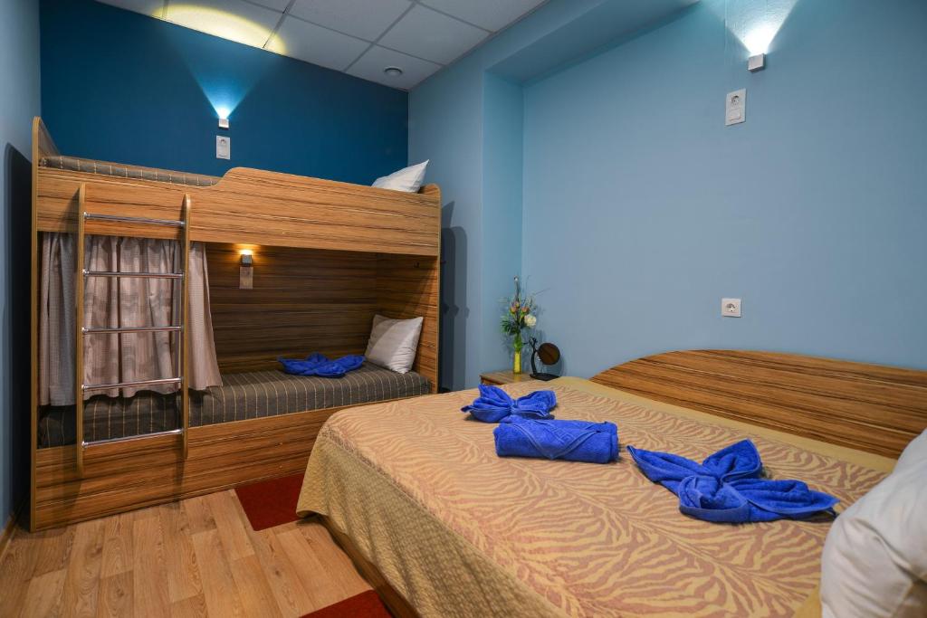 オムスクにあるRed Apple Mini Hotel, hostelのベッドルーム1室(青い枕のベッド2台付)