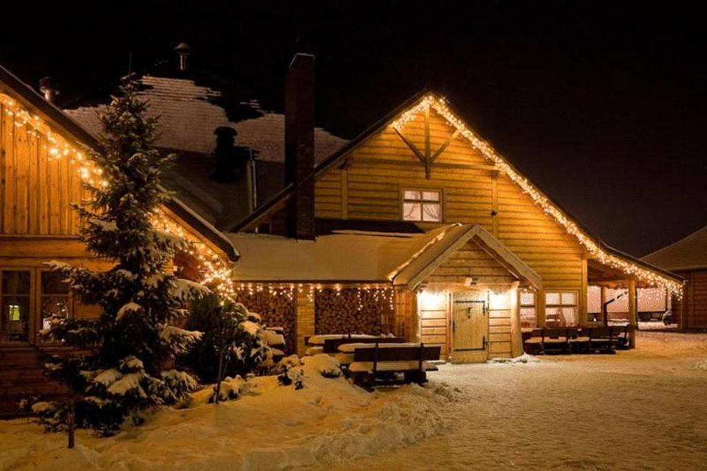 a log building with lights on it at night at Chata Walichnowska in Sokolniki