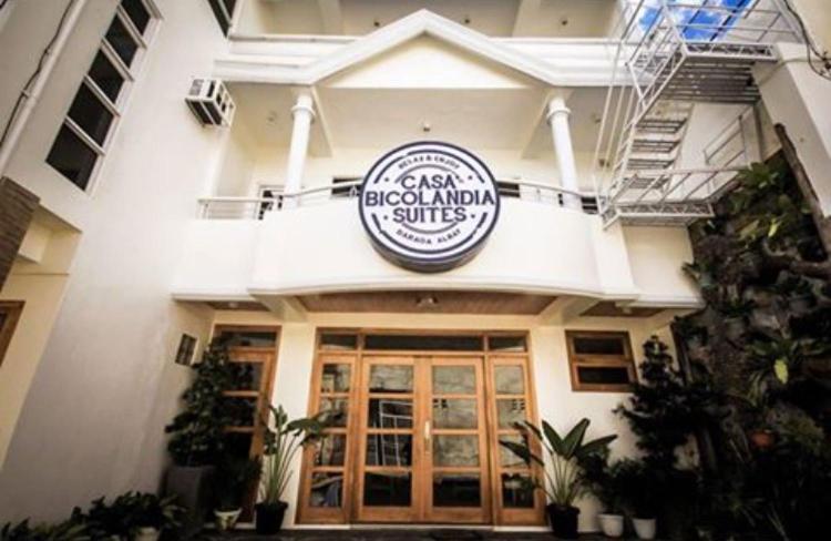 a restaurant with a sign on the front of a building at Casa Bicolandia Suites in Daraga