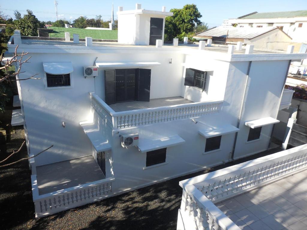 a white house with a staircase on a roof at St Chylifa in Toamasina