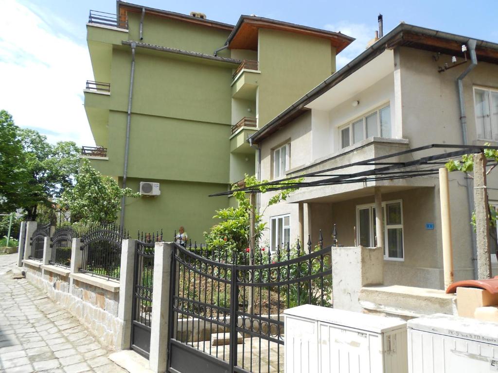 a building with a fence in front of it at Nelly Guest House in Sozopol