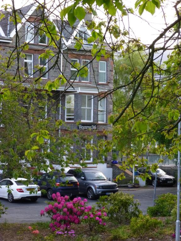 a building with cars parked in a parking lot at Rooms36 in Keswick