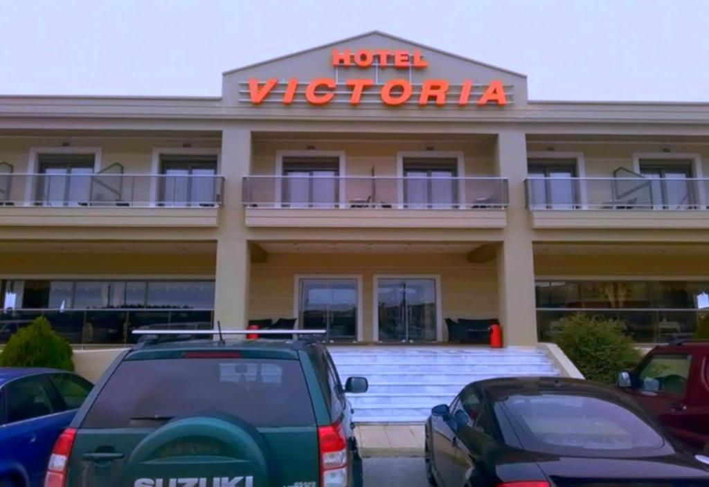a hotel with cars parked in front of it at Hotel Victoria in Kilkís