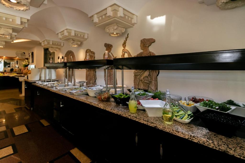 a buffet line in a restaurant with food on it at Lara Park Hotel in Antalya