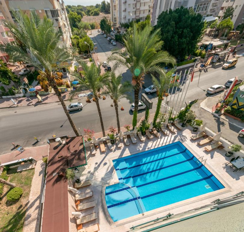 an overhead view of a swimming pool on a building with palm trees at Lara Park Hotel in Antalya