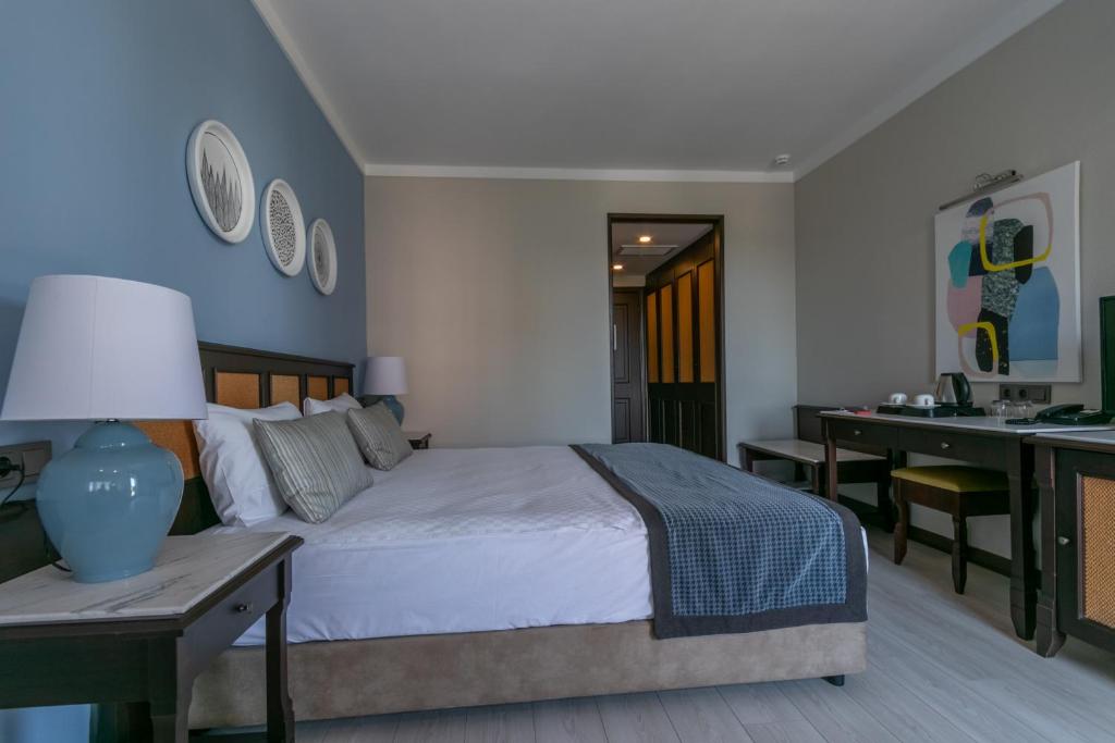 a bedroom with a bed and a desk with a desk at Lara Park Hotel in Antalya