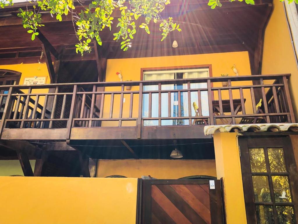 a balcony of a house with a door and a building at Flat Bouganville in Abraão