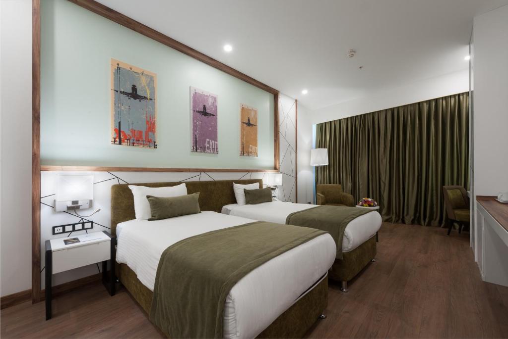a hotel room with two beds in a room at ISG Sabiha Gökçen Airport Hotel in Istanbul