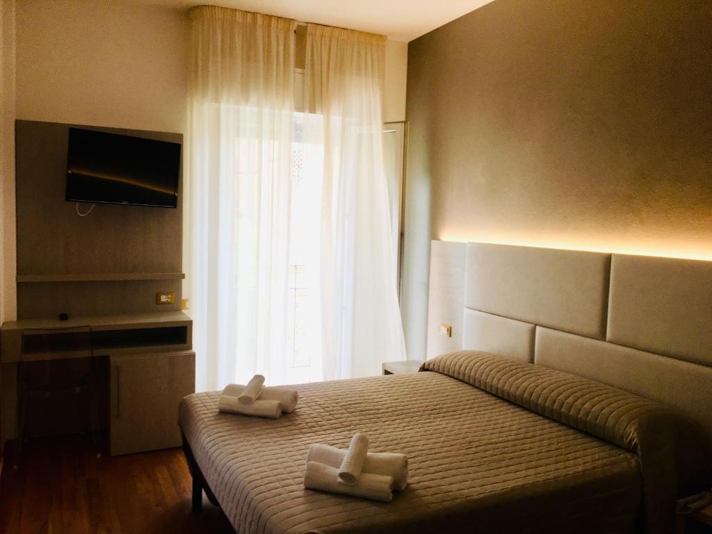 Postel nebo postele na pokoji v ubytování Hotel Monica