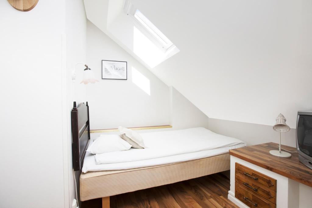 Postel nebo postele na pokoji v ubytování Hotell Lindgården