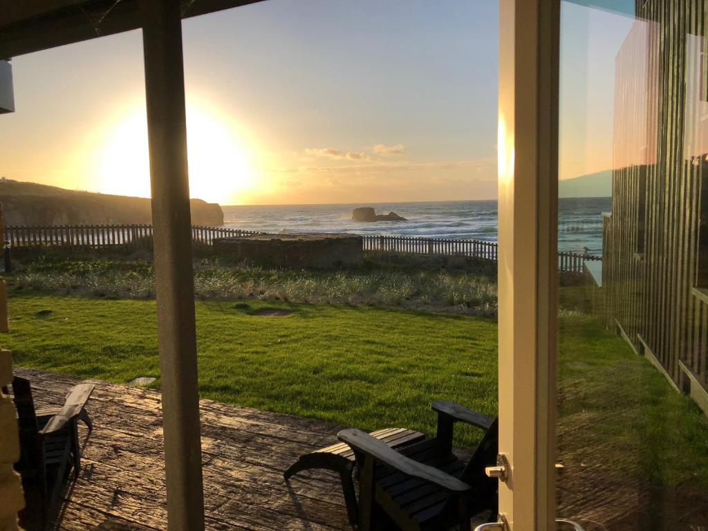 a view of the ocean from the porch of a house at Chapel Rock View, The Dunes in Perranporth