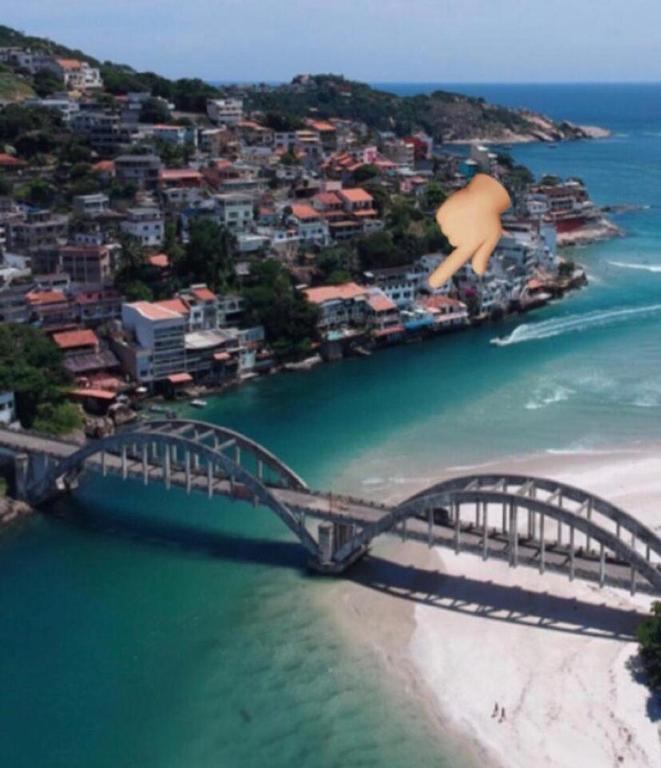 a bridge over a body of water next to a city at Casa Marambaia in Rio de Janeiro