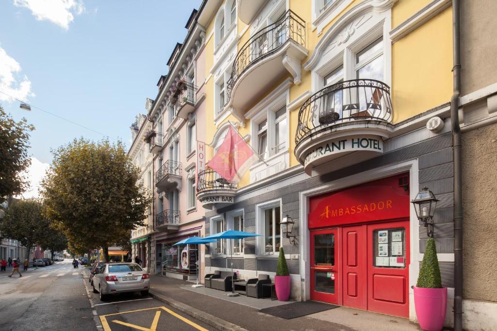 a building with a red door on a city street at Hotel Ambassador in Solothurn