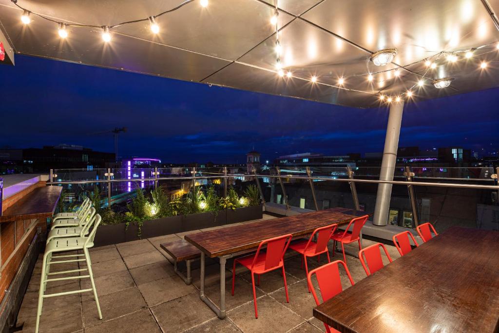 a table and chairs on a rooftop with lights at Jacobs Inn Dublin in Dublin